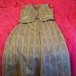 A grey suit top with a grey matching skirt